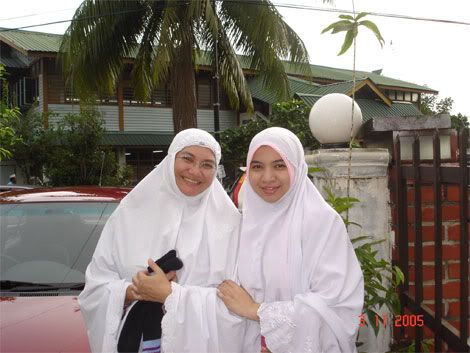 Mama and my sister in front of my house