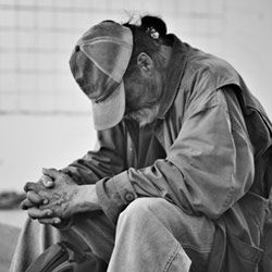 homeless man praying