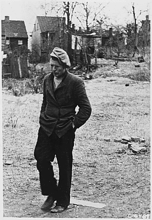 Image of man walking in 1930's shanty town