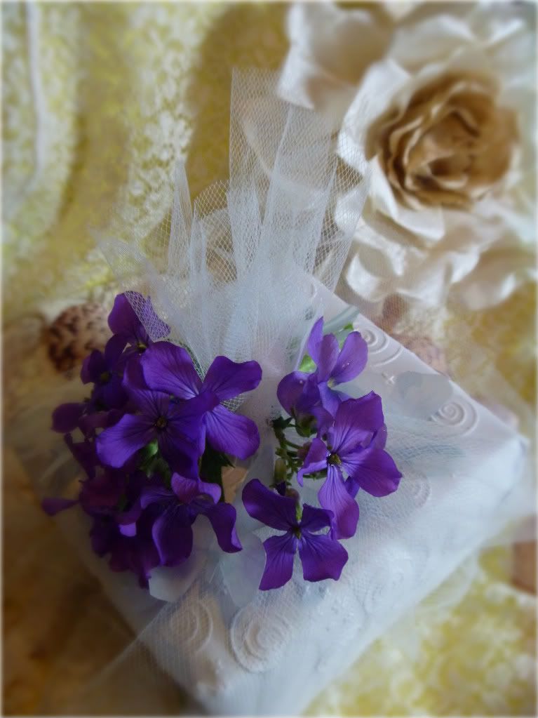 white embossed wrapping paper tulle wrapped gift purple flowers vellum butterflies