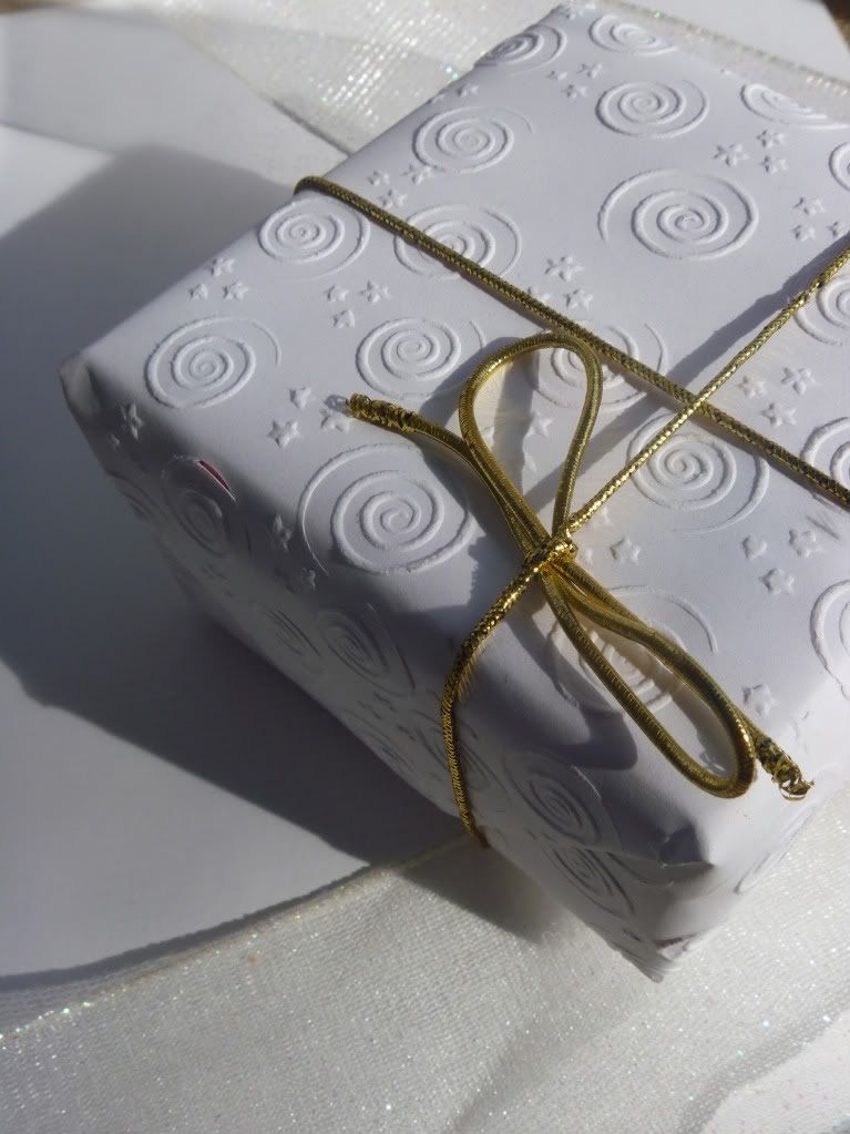 white embossed handmade gift wrapped present