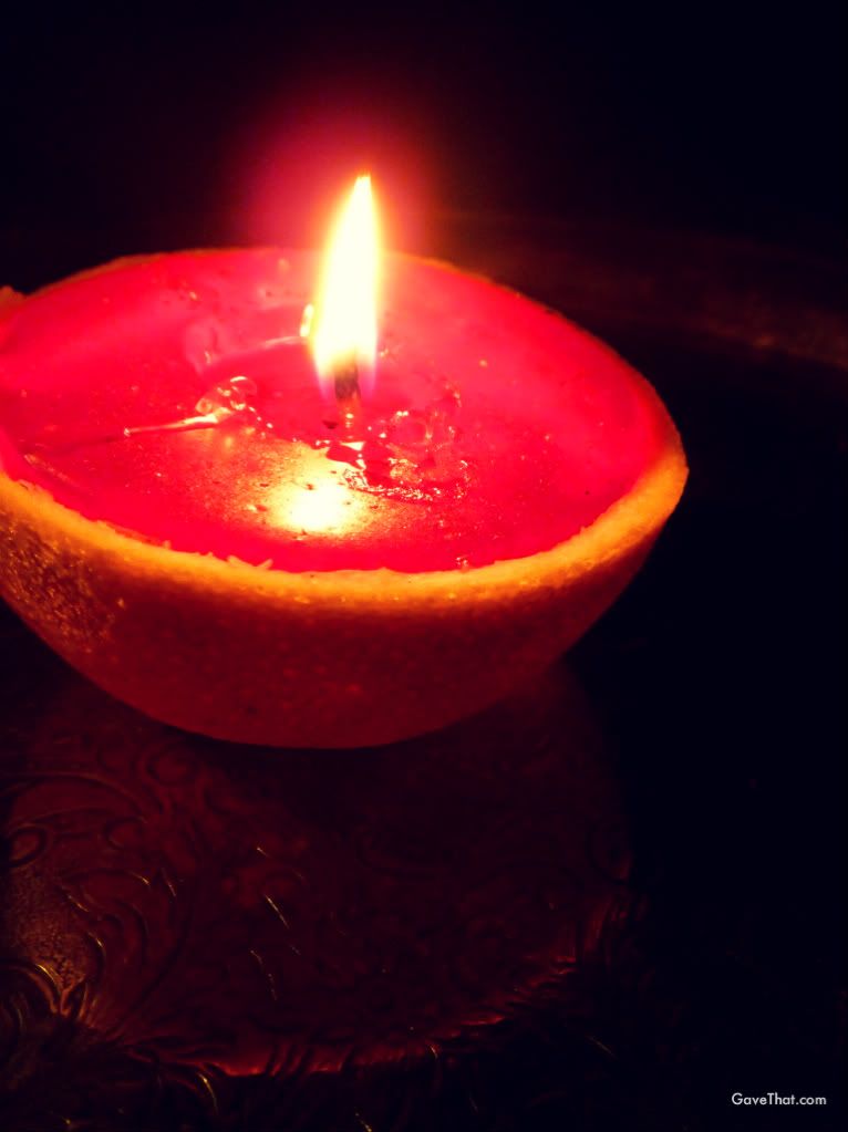 Blood Orange Peel candle burning on a vintage silver platter