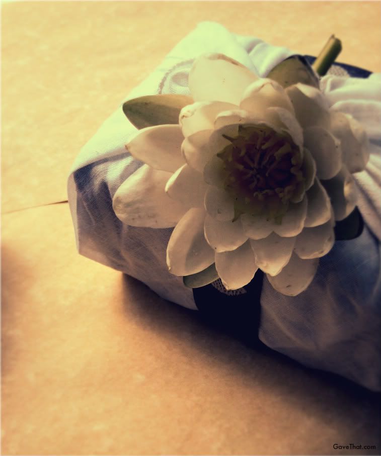 Linen wrapped gift with white waterlily and Egyptian ribbon