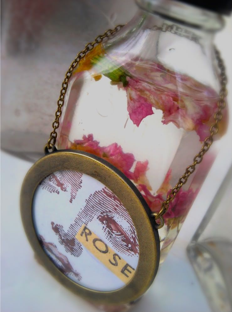 Dried roses in bath oil with metal miniature picture frame gift tag