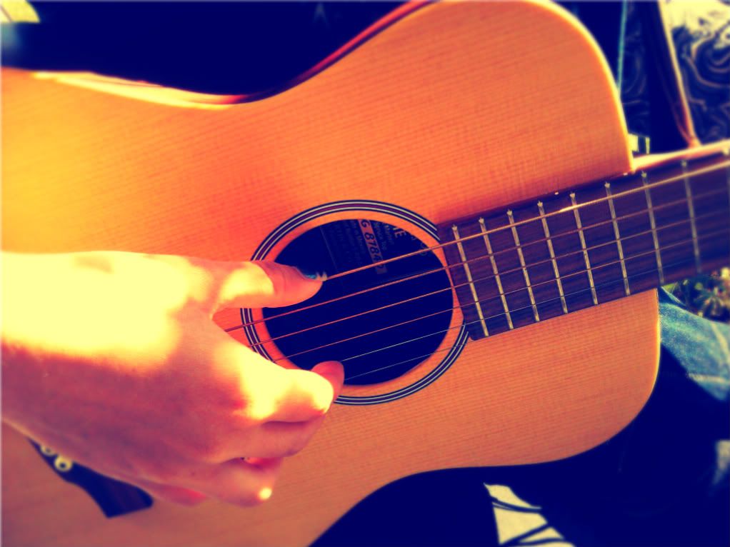 Magda playing her Little Martin LX 1 E guitar given to her as a gift