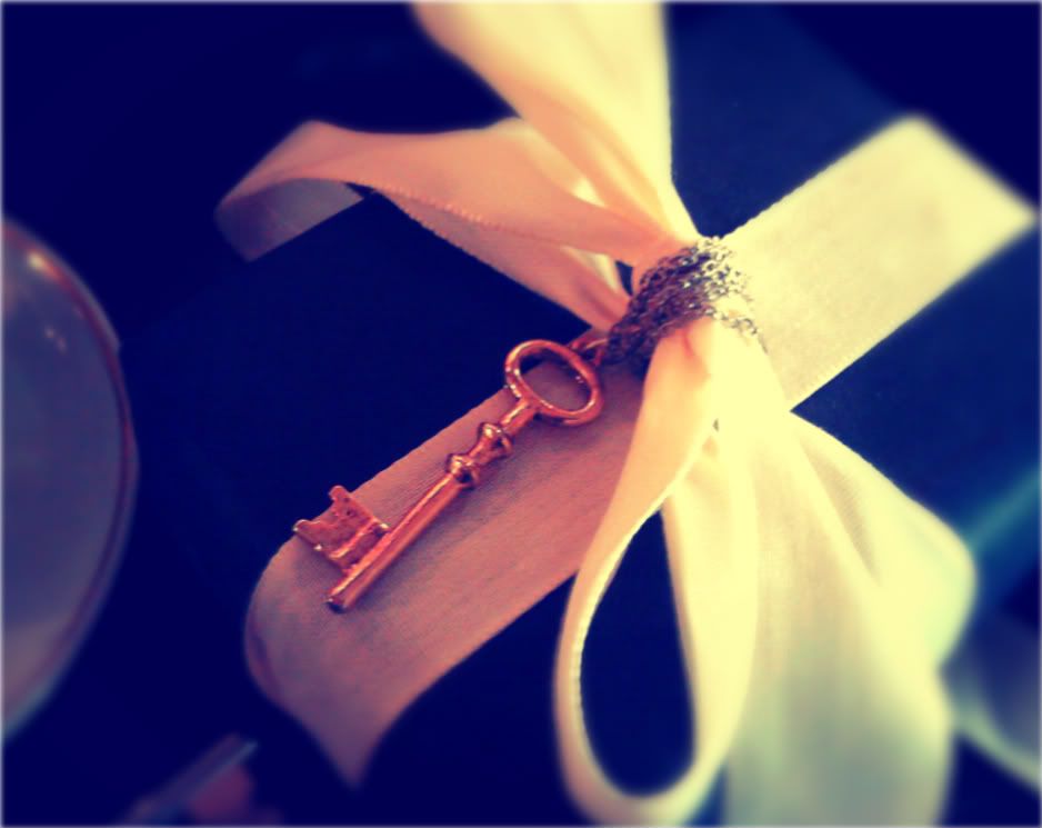 key necklace embellishing a gift bow