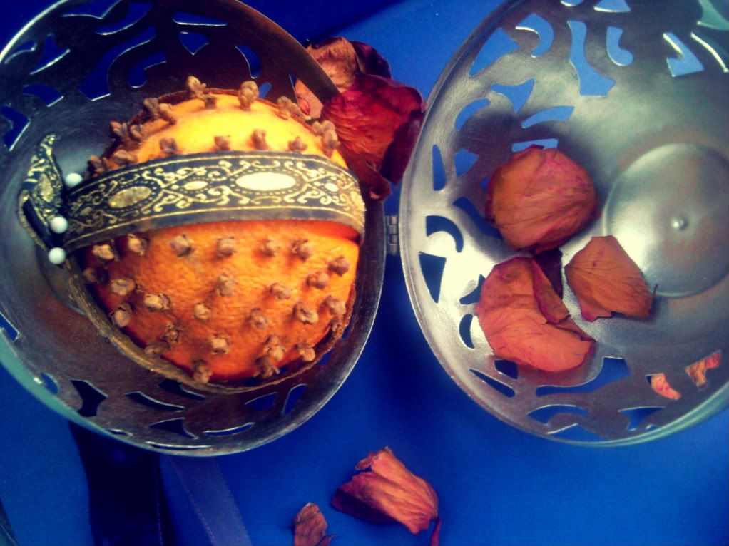 Metal pomander with orange pomander and rose petals inside