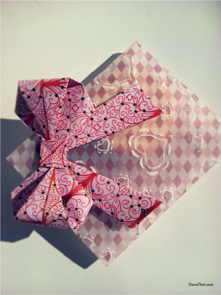 Vellum paper envelopes embossed with hearts and embellished with an origami paper bow gift wrap look for Valentines day