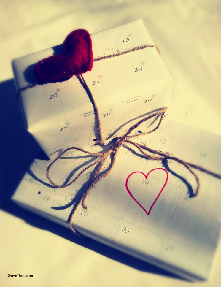 Recycling calendar pages into wrapping paper with a handmade felt heart pin