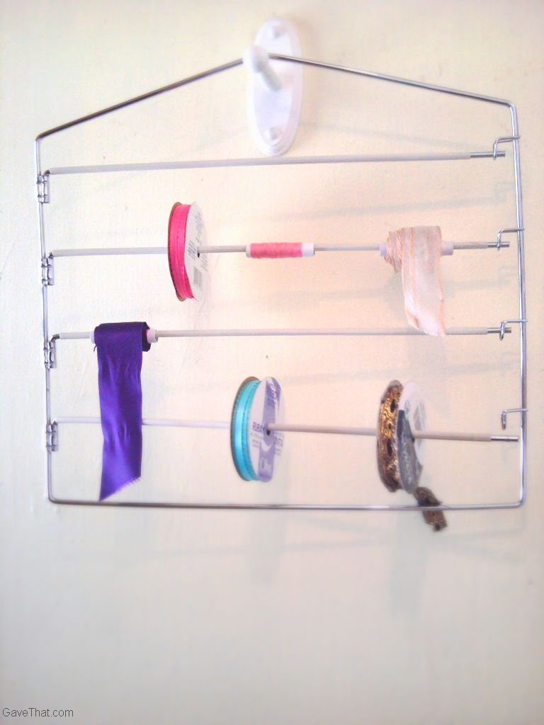 Organizing spools of ribbon and butchers twine on pant hangers idea