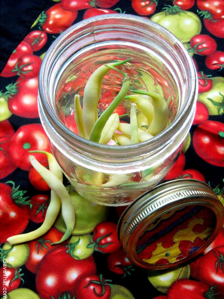 Packing garden vegetables for gift giving using mason jars and gift wrap on the lids