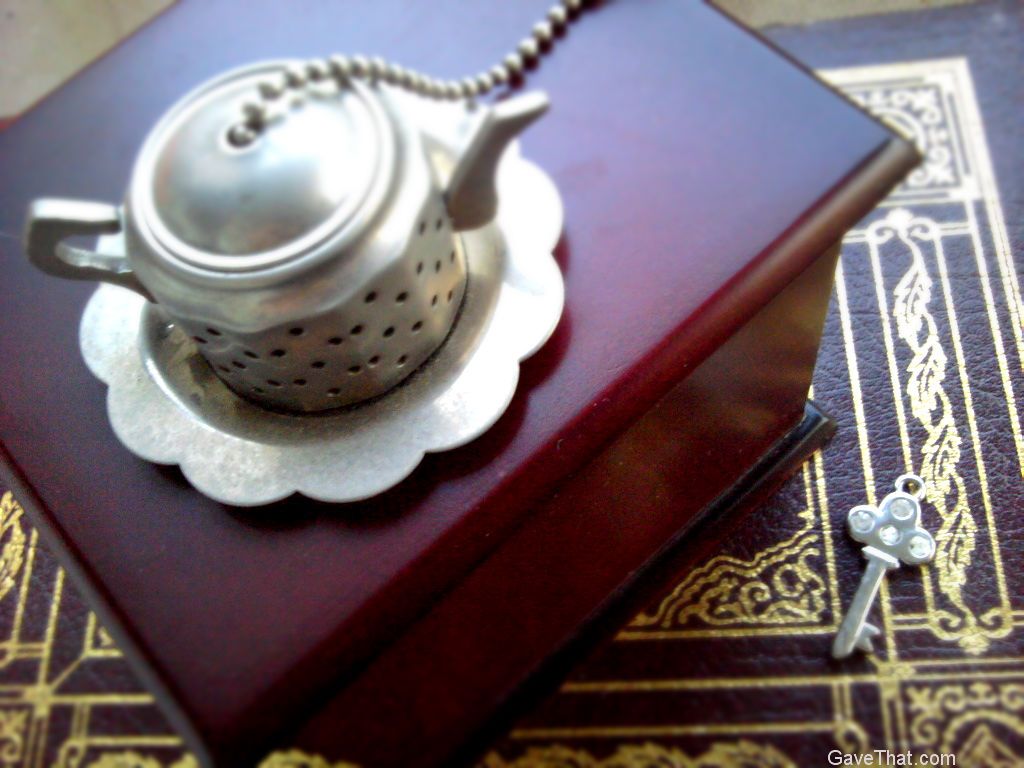 Tea chest and a tiny tea ball in the shape of a tea pot