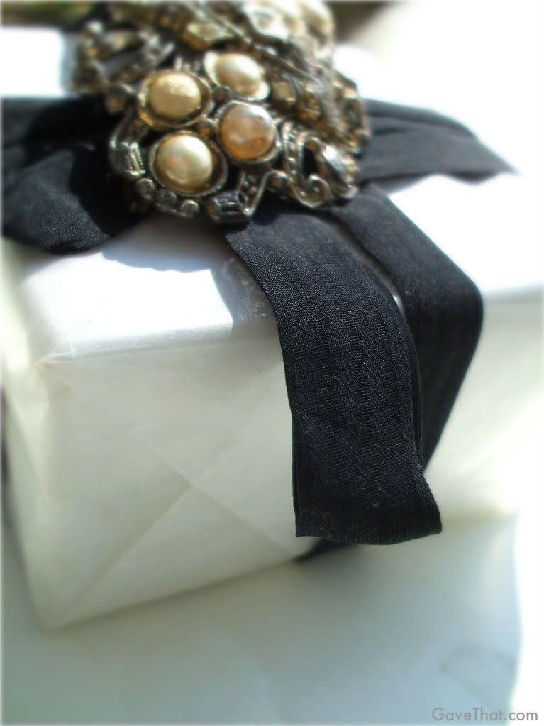 mam for gavethat white gift wrapped in black ribbon adorned with vintage pin