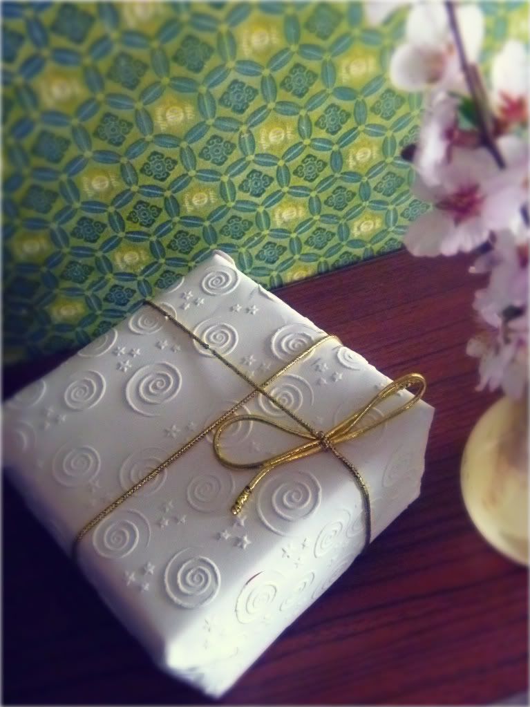 embossed white paper wrapped gift