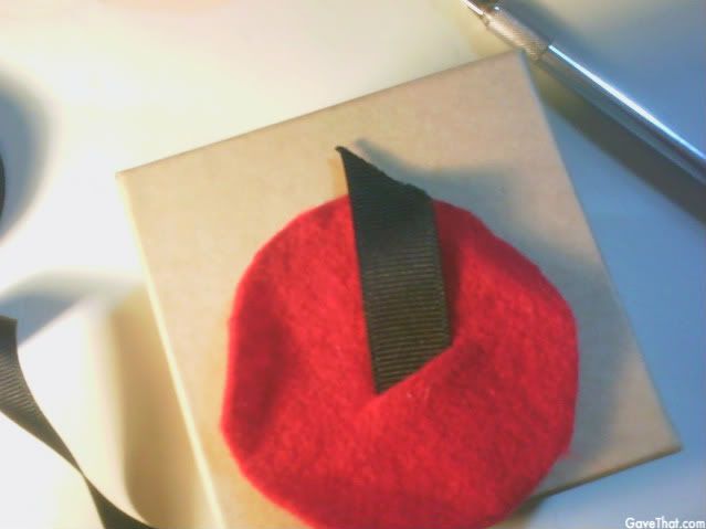 mam for gavethat diy gift wrap step two pushing ribbon through felt circle