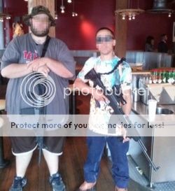 image of two guys out in public with their loaded rifles