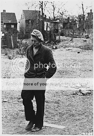 Image of man walking in 1930's shanty town
