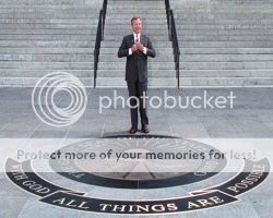 image of Former Ohio Governor George Voinovich poses in 1998 with the state seal and motto he had installed at the Statehouse
