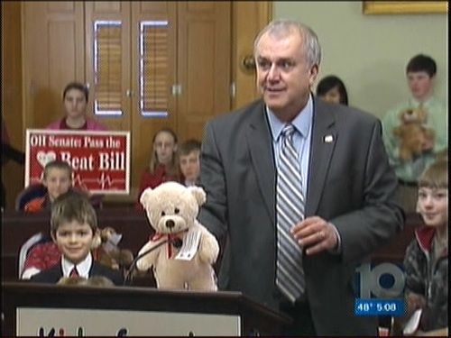 Cliff Hite squeezing a Teddy Bear